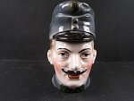 Porcelánová hlava RU vojáka sloužící jako pokladnička, období I. sv války