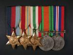 Spojka vyznamenání (Hvězda 1935-45, Hvězda Afrika, Italská hvězda, Medaile obrany, Válečná medaile) vše na jméno G.E..LUDDITT