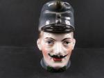 Porcelánová hlava RU vojáka sloužící jako pokladnička, období I. sv války